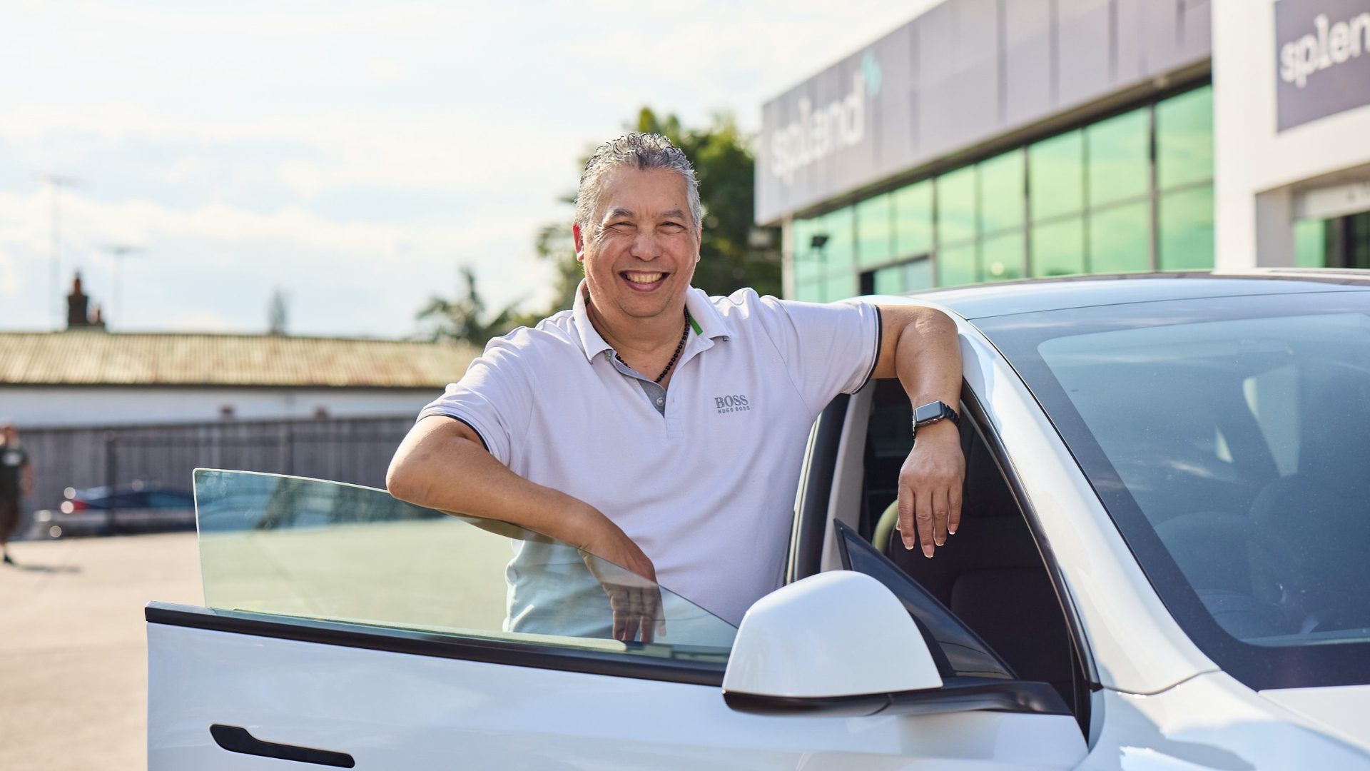 A driver beside a Splend car